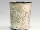 a silver cup that is sitting on a table