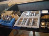a table with silverware and utensils on it