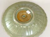a green plate with a tag on it on a table