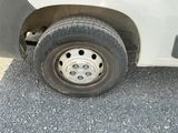 a flat tire on the side of a white van
