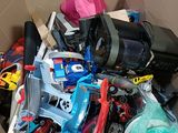 a cardboard box filled with assorted toys and other items
