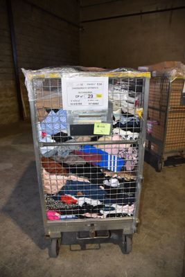 a cart with a bunch of clothes on it in a warehouse