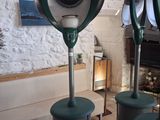 three green blow dryers sitting on top of each other in a room