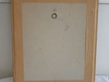 an old picture frame sitting on top of a white table