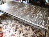 a marble table in the middle of a living room