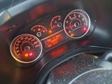 a close up of a car dashboard with various gauges