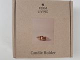 candle holder in a cardboard box on a white surface