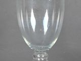 a glass that is sitting on a table in front of a wall