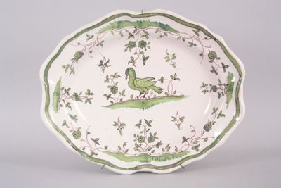 a green and white plate with a bird on it