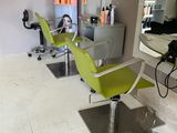 a picture of a hair salon with a lot of chairs