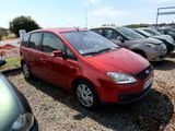 a red car that is parked in a parking lot