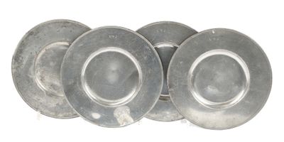 three silver plates are stacked on top of each other on a white surface