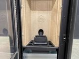 a black and white stove inside of a metal cabinet