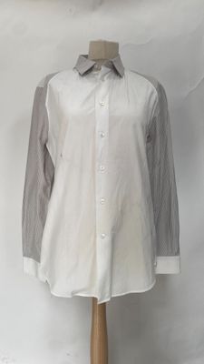 the shirt is white and grey with stripes on the sleeves