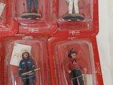 six small plastic figurines of people in red boxes
