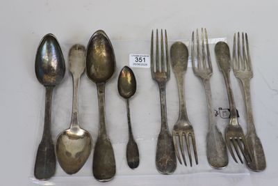 a lot of silver spoons and forks on the table
