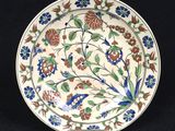 a close up of a plate with flowers on it on a black background