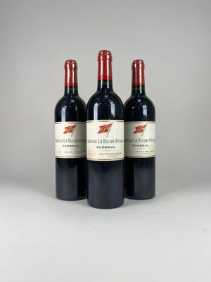 three bottles of red wine sitting on top of a white table