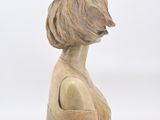 sculpture of a woman ' s head with a bun on top of her head