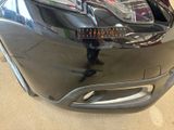 a close up of a car ' s headlight with a sticker on it