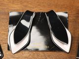 a pair of black and white shoes on a wooden table