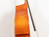 a cello that is sitting on a stand on the floor