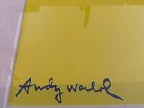 signed autographed photograph of a yellow and black bowl on a table