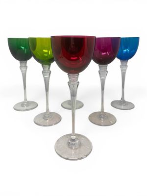 several different colored wine glasses are lined up in a row