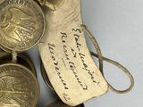 a small bowl of coins with a note attached to it