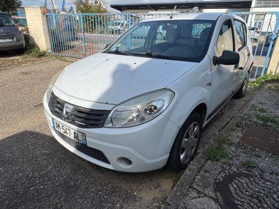 la petite voiture blanche est garée sur le bord de la route