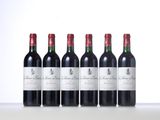 four bottles of red wine lined up in a row