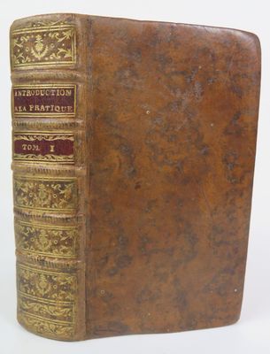 an old book sitting on top of a table next to a white background