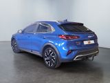 the rear end of a blue suv parked in a room