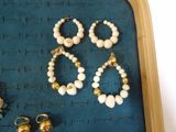 several pieces of jewelry are displayed on a tray on a table