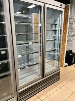 two refrigerators that are sitting in the middle of a room