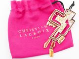 christian lacrox pink bag with a gold cross charm and a pink bag with a gold cross charm on it