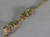 gold plated tiger head charm on a gold plated snake head