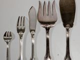 a lot of forks and spoons that are on the table