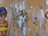many glasses with different designs on them on a shelf