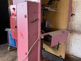 a pink machine that is sitting in a garage