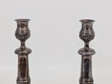 pair of antique silver plated candlesticks on a white background
