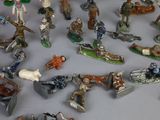 many figurines of different types and sizes on the table