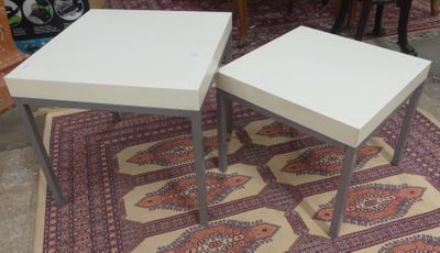 two tables that are sitting on a rug on the floor