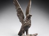 une image représentant une statue en bronze d'un oiseau perché sur une branche