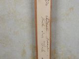 a picture of a wooden sign with writing on it