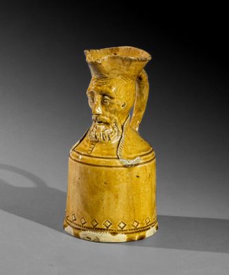 une image représentant un vase jaune sur lequel figure une tête d'homme