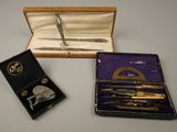 a box with a pen and a pair of scissors in it