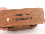 a person holding a wooden box with a stamp on it