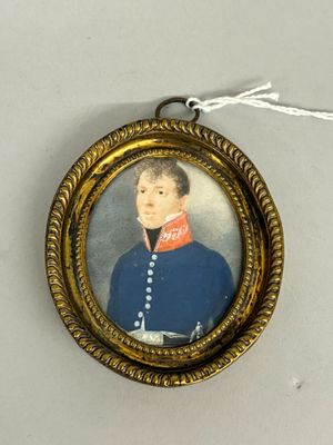 an old picture of a man in a blue uniform is hanging on a wall