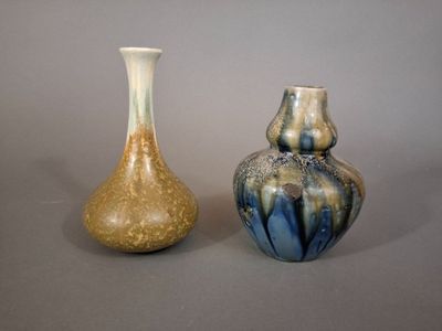 two vases sitting next to each other on a table